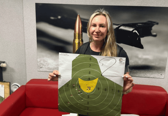 Guest holding a target sheet after a session, Krakow shooting range