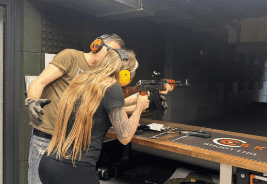Guest firing a rifle with instructor guidance, Krakow shooting range