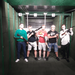 Group of five holding firearms at a Krakow shooting range