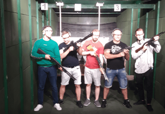 Group of five holding firearms at a Krakow shooting range