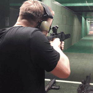 Guest aiming a rifle down the range, Krakow shooting range